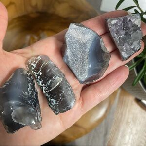 Set of four polished tumbled agate with amethyst pocket stones